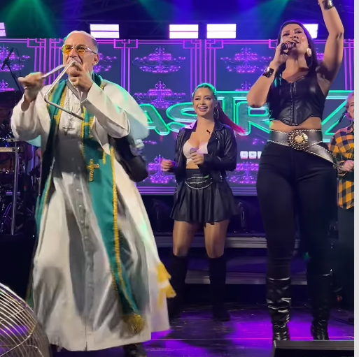 PADRE FORROZEIRO: SACERDOTE SOBE AO PALCO, TOCA TRIÂNGULO E DANÇA FORRÓ EM SHOW DO MASTRUZ COM LEITE